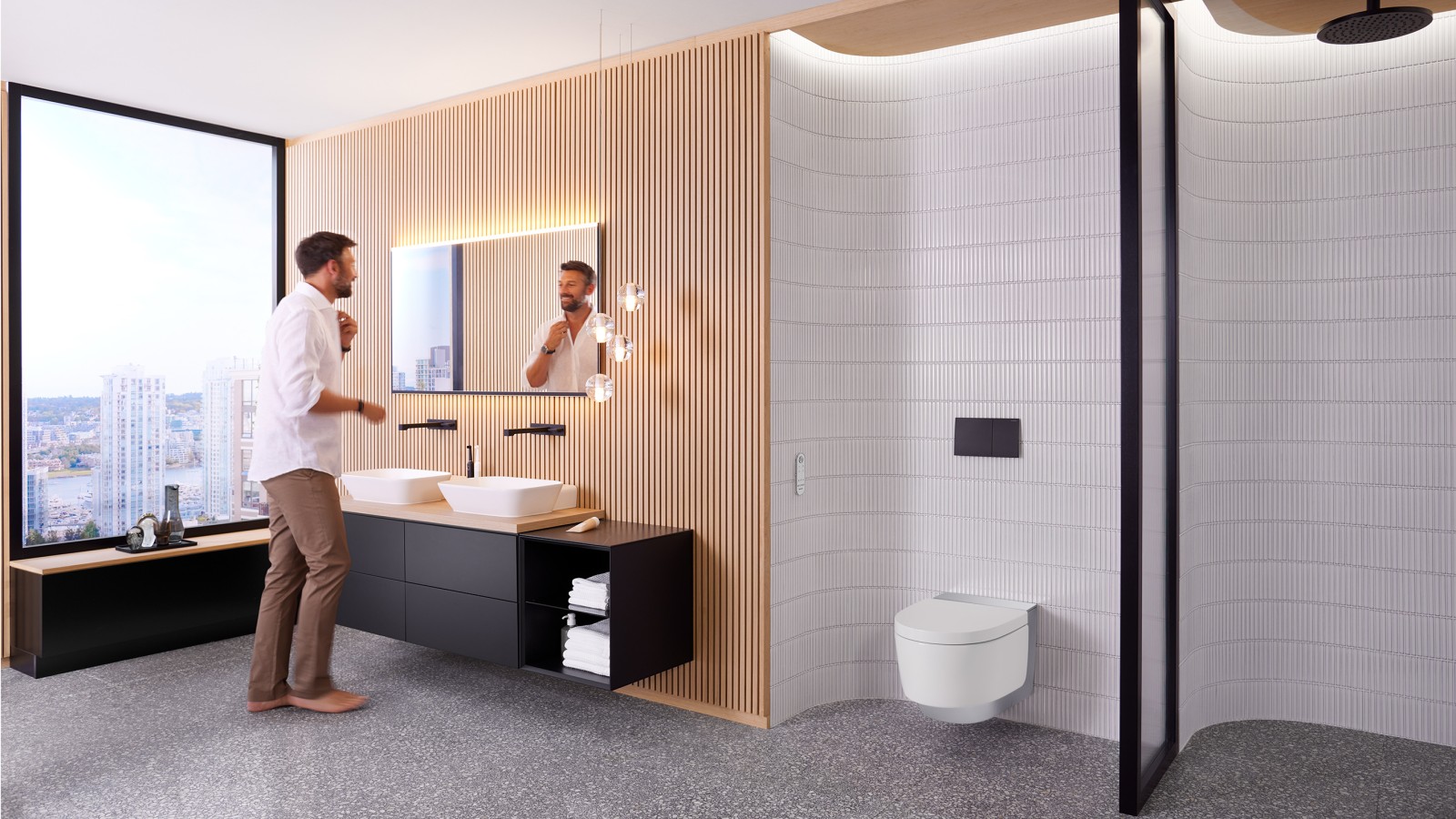Un uomo in bagno davanti allo specchio Geberit Option Plus Square e ai mobili da bagno Geberit ONE neri (© Geberit) Un uomo in bagno davanti allo specchio Geberit Option Plus Square e ai mobili da bagno Geberit ONE neri (© Geberit)