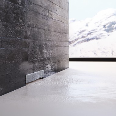 Évacuation murale Geberit dans une paroi maçonnée noire Évacuation murale Geberit dans une paroi maçonnée noire